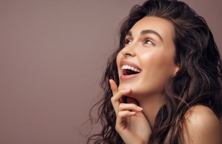 woman smiling after eyelid surgery