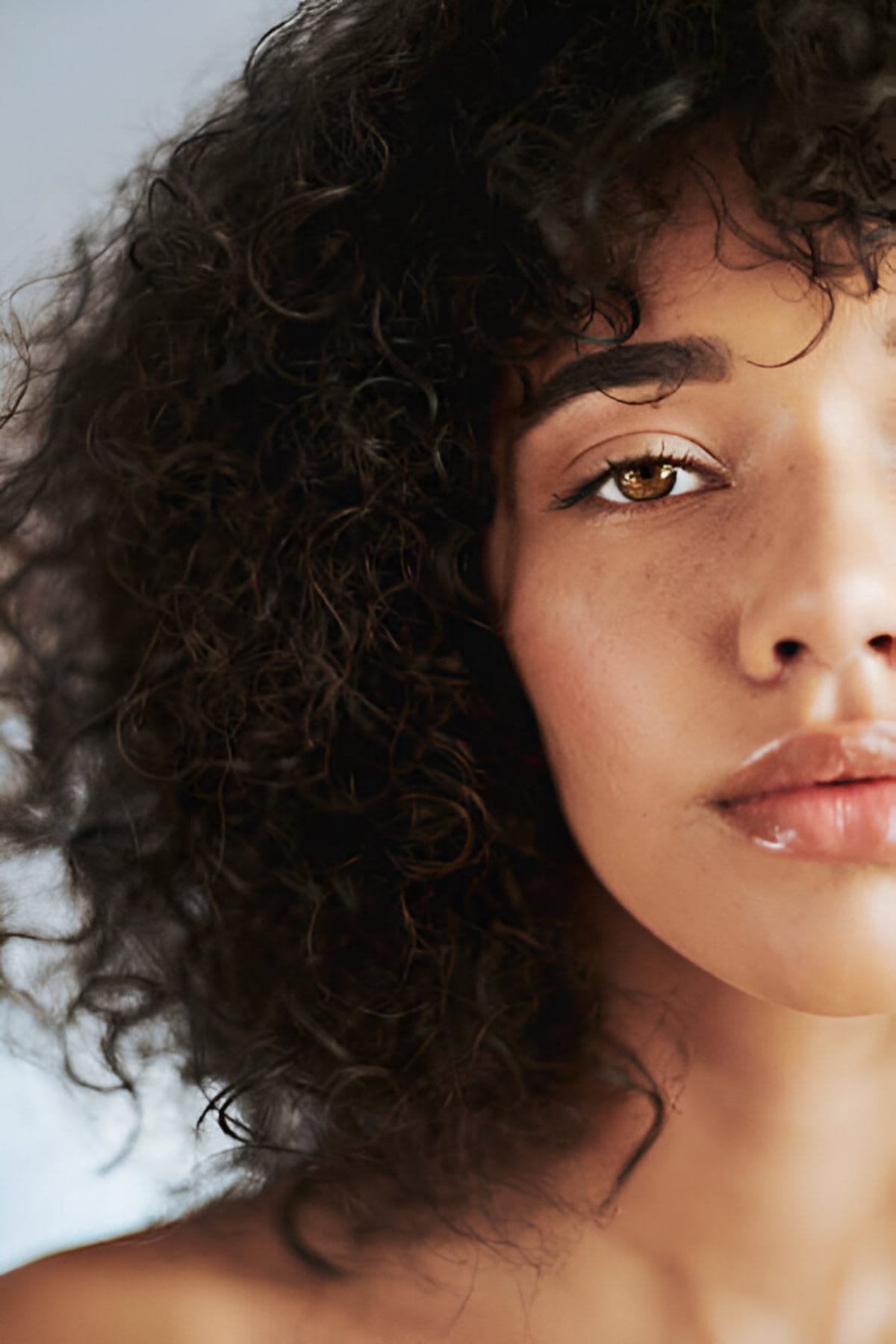 Face, skin and wellness with an attractive young female touching her cheek after natural care