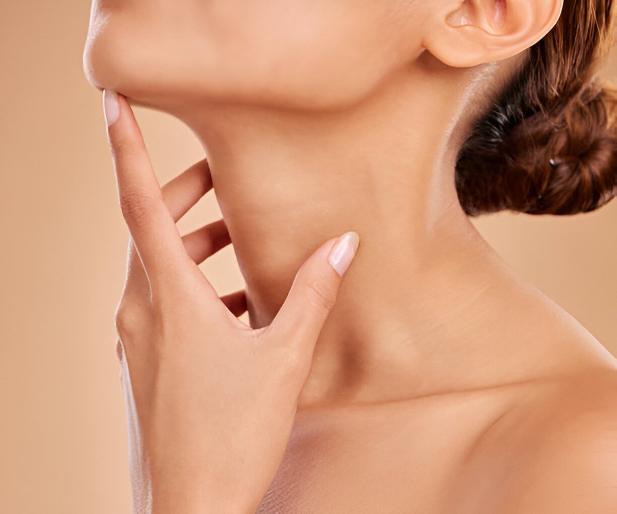 Close-up of a woman's smooth jawline and neck, highlighting youthful skin and facial contours
