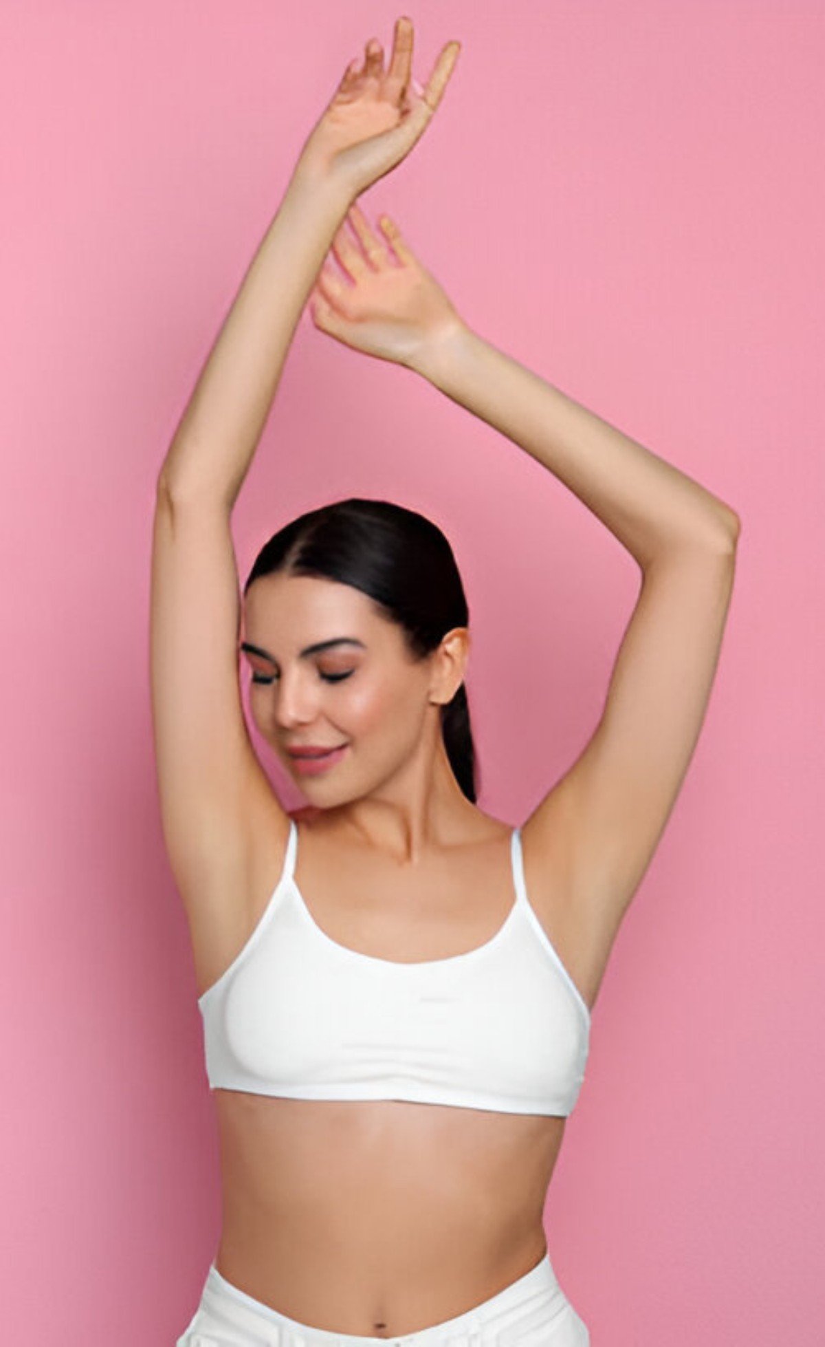 Young woman showing Arm Lift on pink background