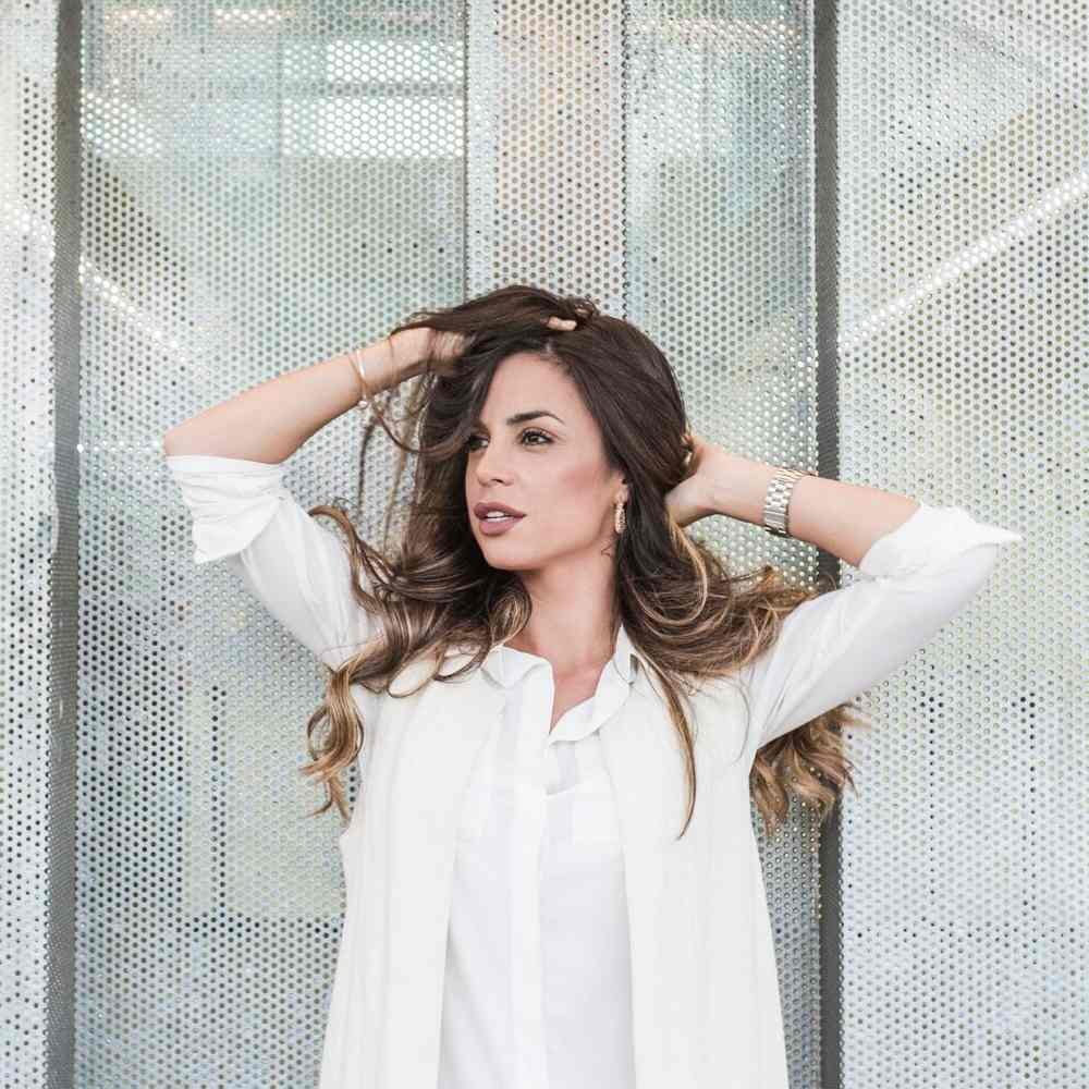 Beautiful woman posing near wall